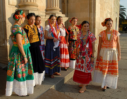 Mexican ladies in colorful dresses Mexican wedding via Style Me Pretty